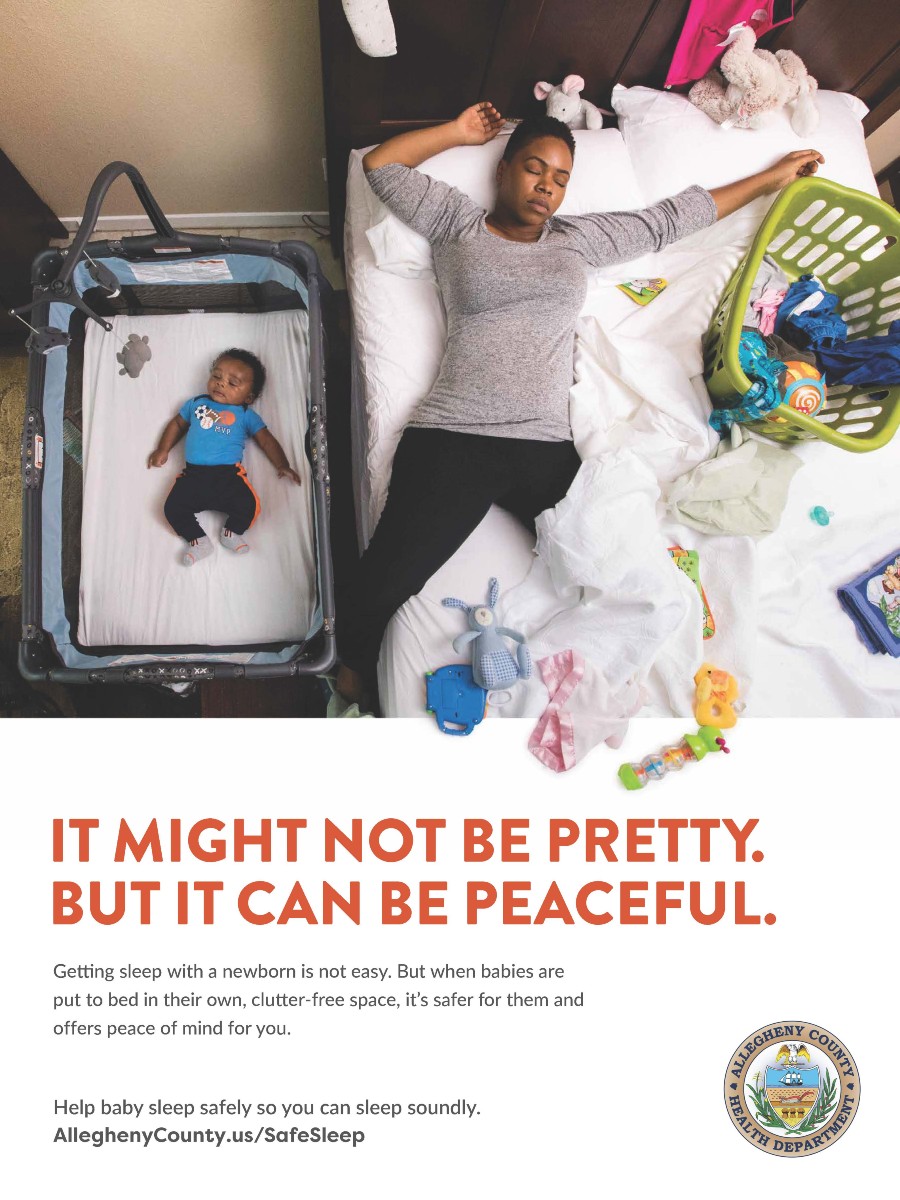 Mom asleep on bed, baby safely in bassinet