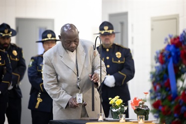 Fr. Peter Mawanda rings the bell.
