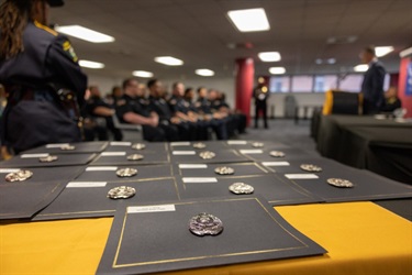 Diplomas and badges were awarded to the new correctional officers.