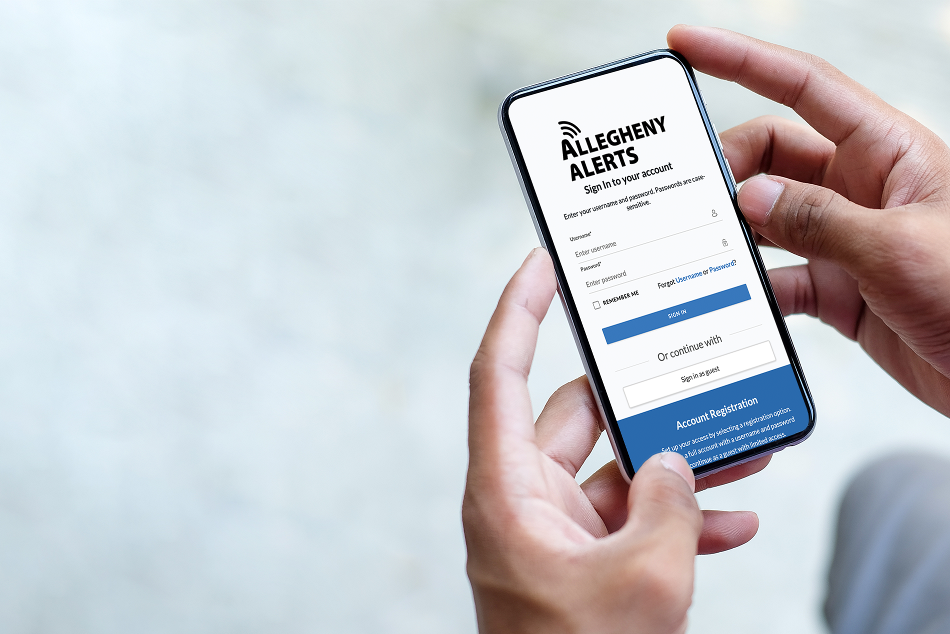 Someone holding a phone with the Allegheny Alerts signup screen visible