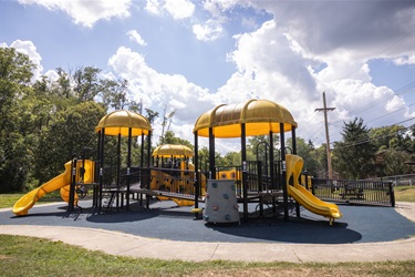 Boyce Park OBlock Playground wide shot showing slides and activities of playground set