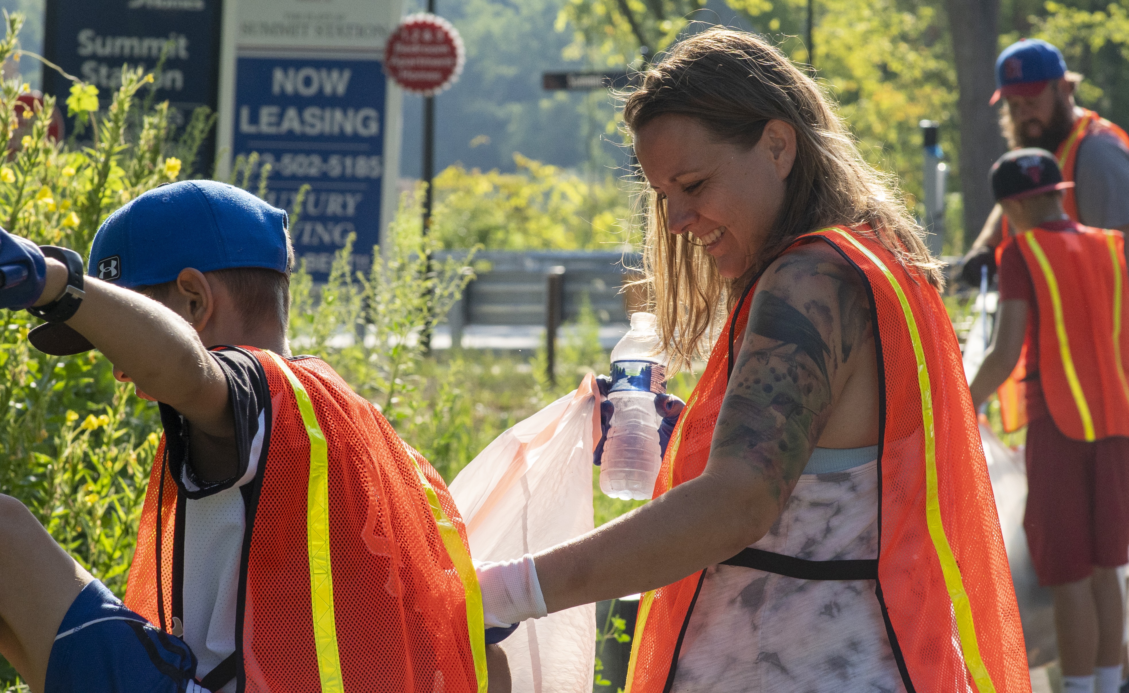 A family helping to clean up litter along a county roadway