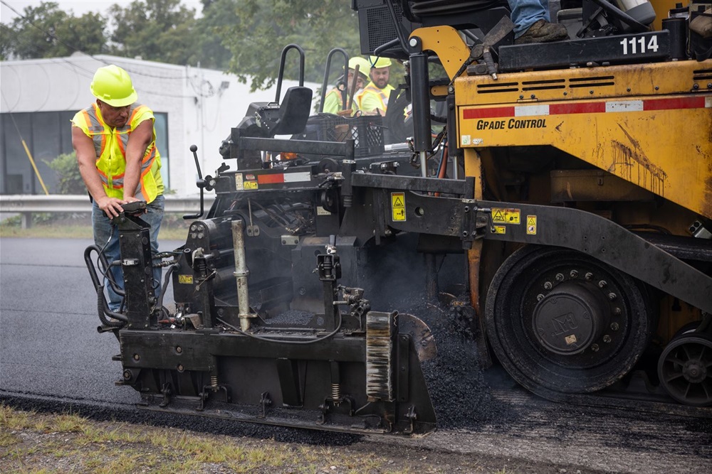 An Allegheny County Public Works Laborer operates a paving machine